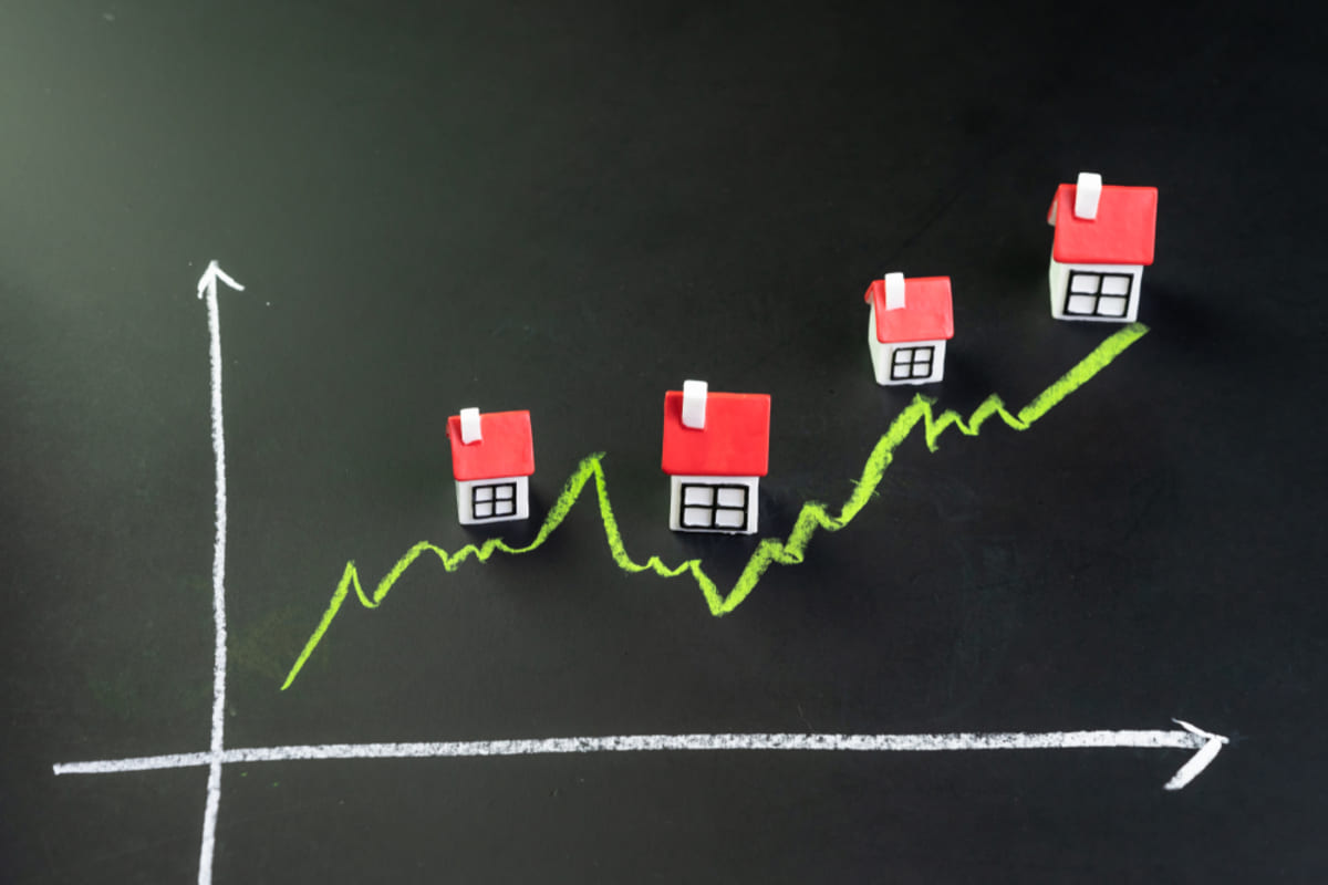 A graph going up with houses above