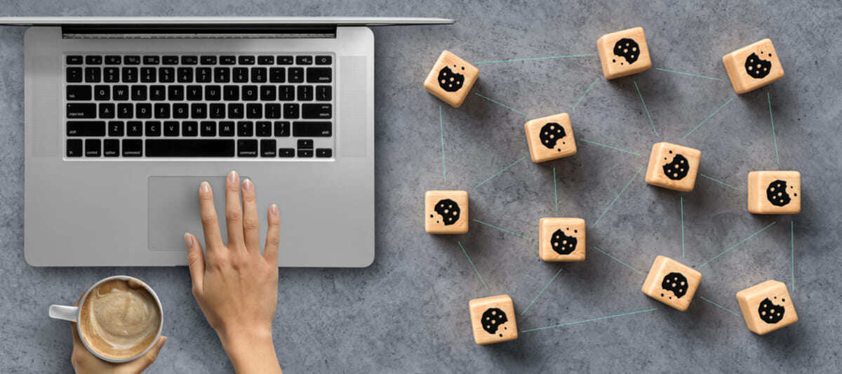 A laptop and cookie icons making a map on a table