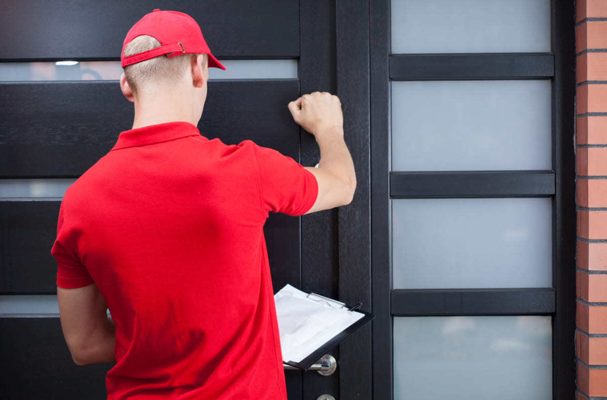 Back of man knocking on a door
