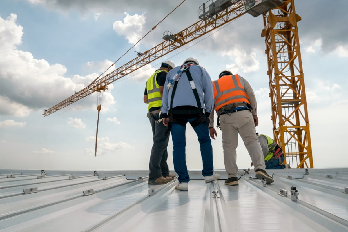 Roofing contractors standing on a roof