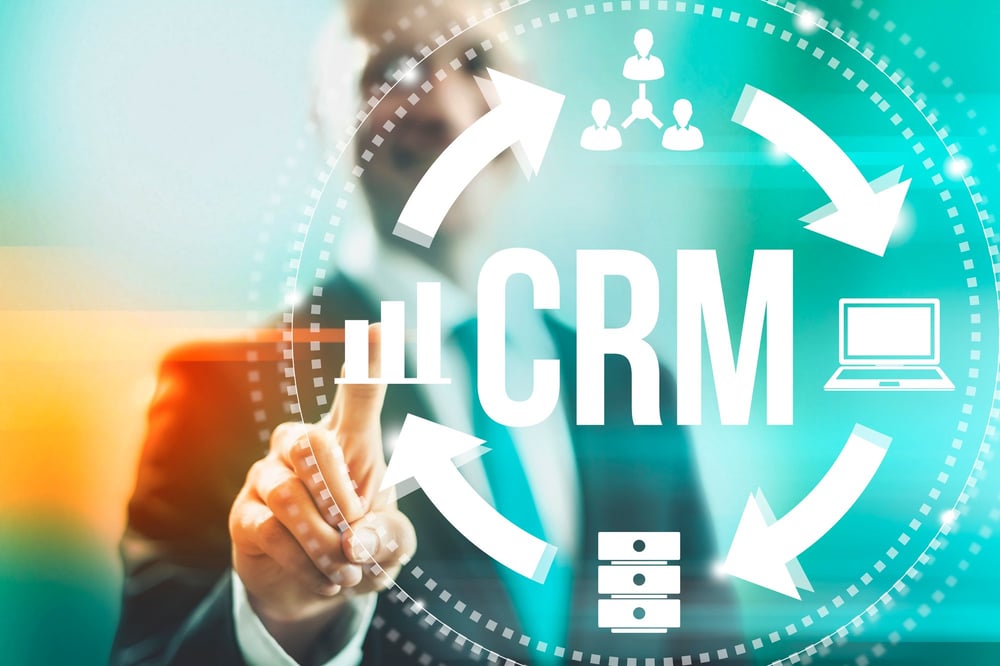 A man pointing at a CRM graphic, what is a crm in real estate concept? 