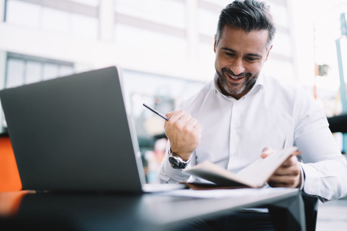 A businessman is happy about reaching goals, property management marketing goals concept