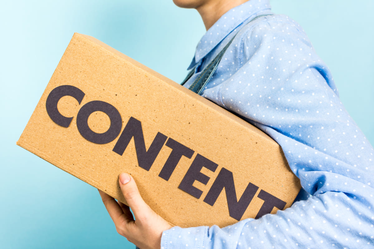A person carrying a box with content on it, content marketing strategy concept