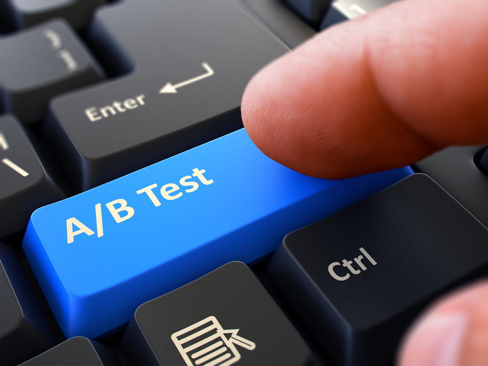 AB Test - Written on Blue Keyboard Key. Male Hand Presses Button on Black PC Keyboard. Closeup View. Blurred Background.-1