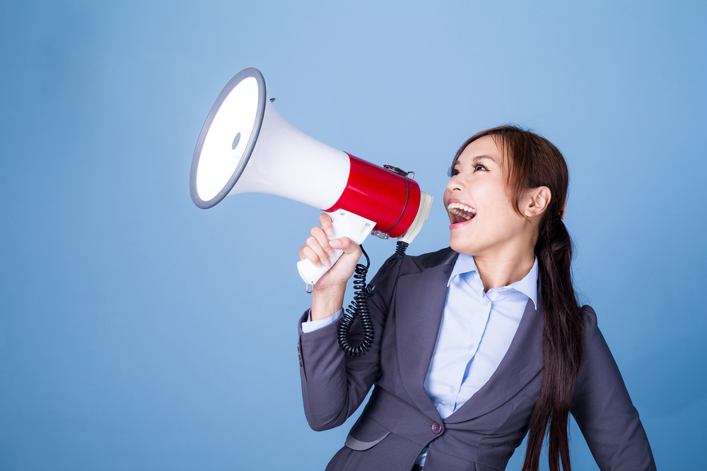 Businesswoman making announcement with megaphone, updating property management websites concept. 