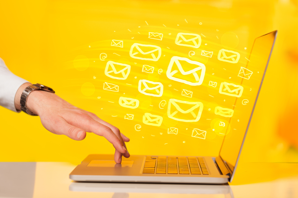 A hand sending an email from a laptop, how can email marketing fuel your overall inbound strategy?