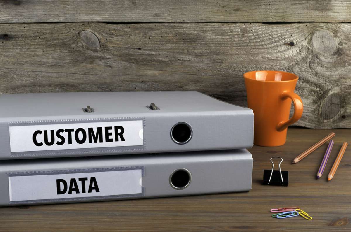 Customer Data - two folders on wooden office desk