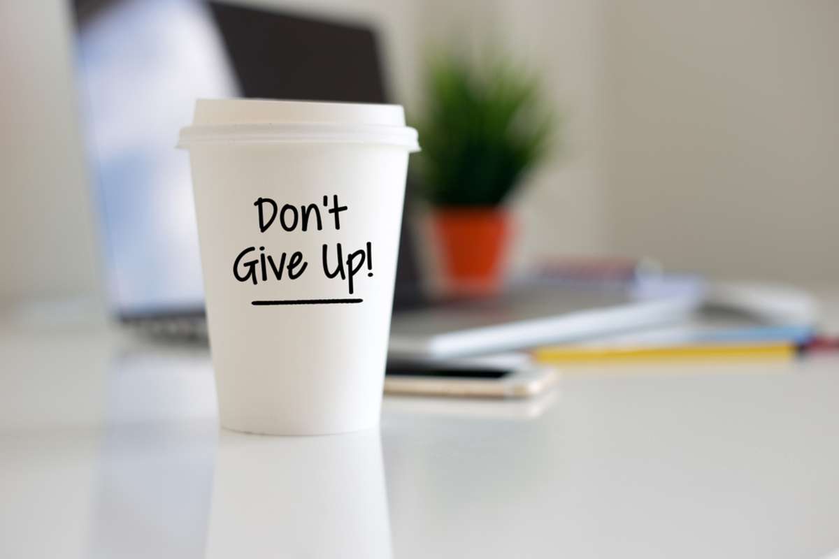 Dont Give Up on a coffee cup, consistent property management blog concept