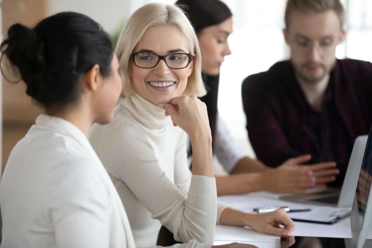 Female professionals talking at workplace