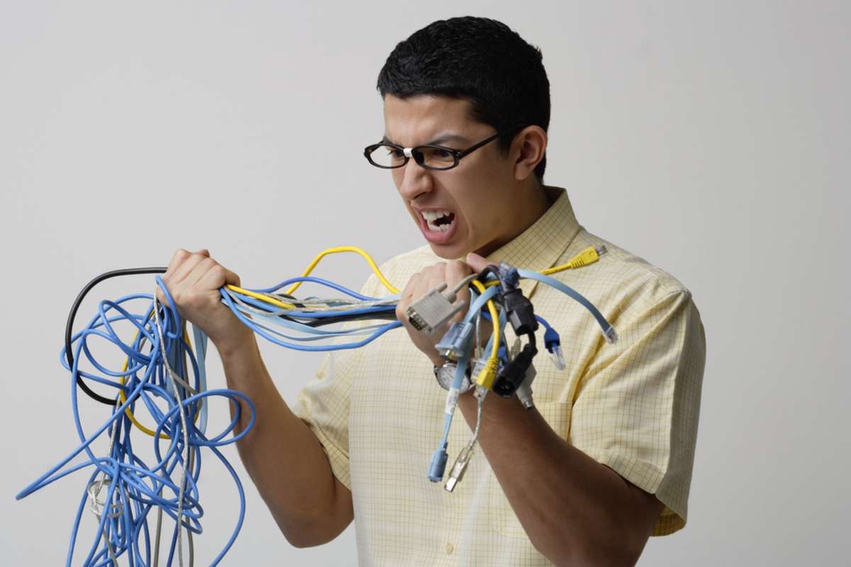 Frustrated man with tangled wires
