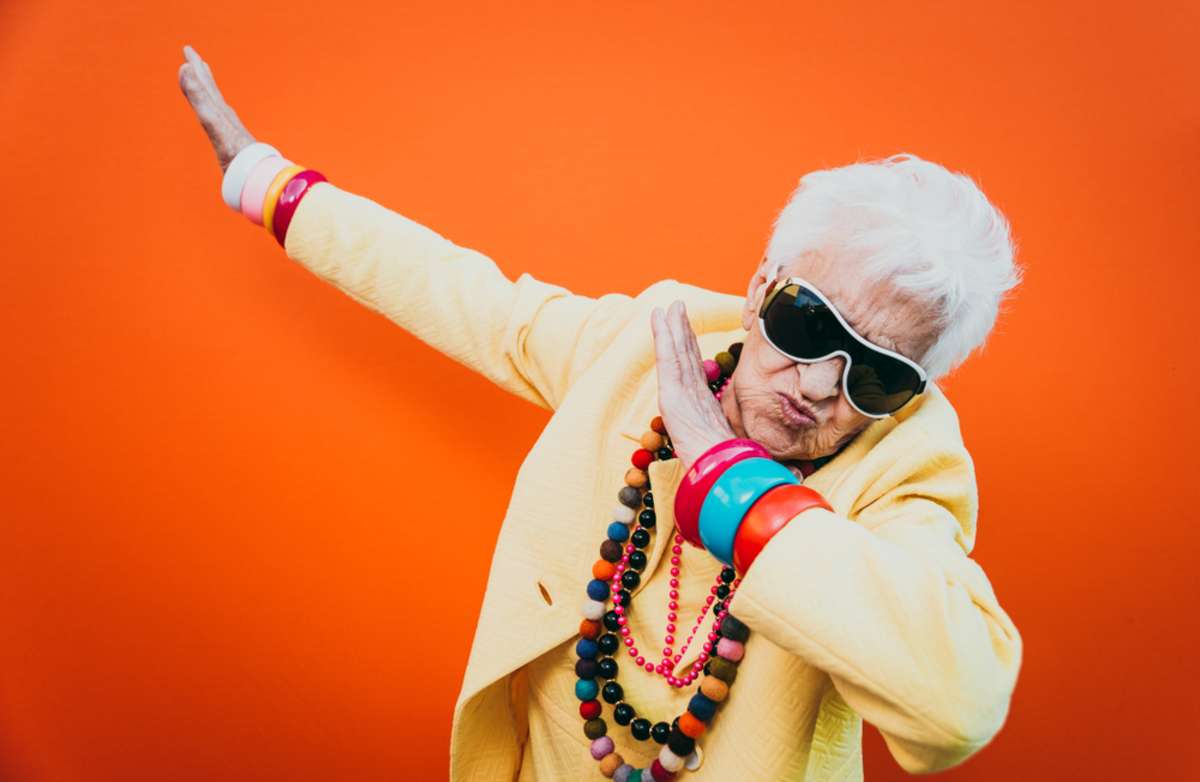 Funny old woman doing an outdated dance move, updating website content concept