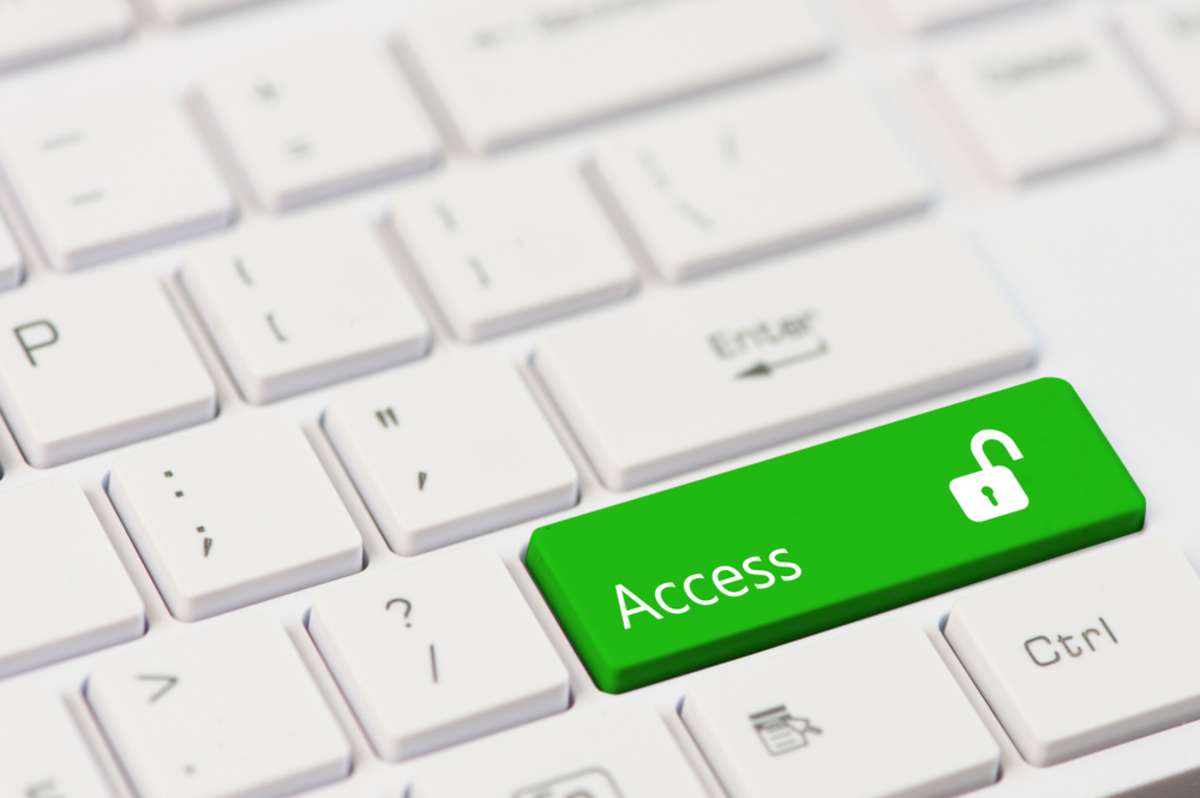 Green key with text Access and open padlock icon on white laptop keyboard