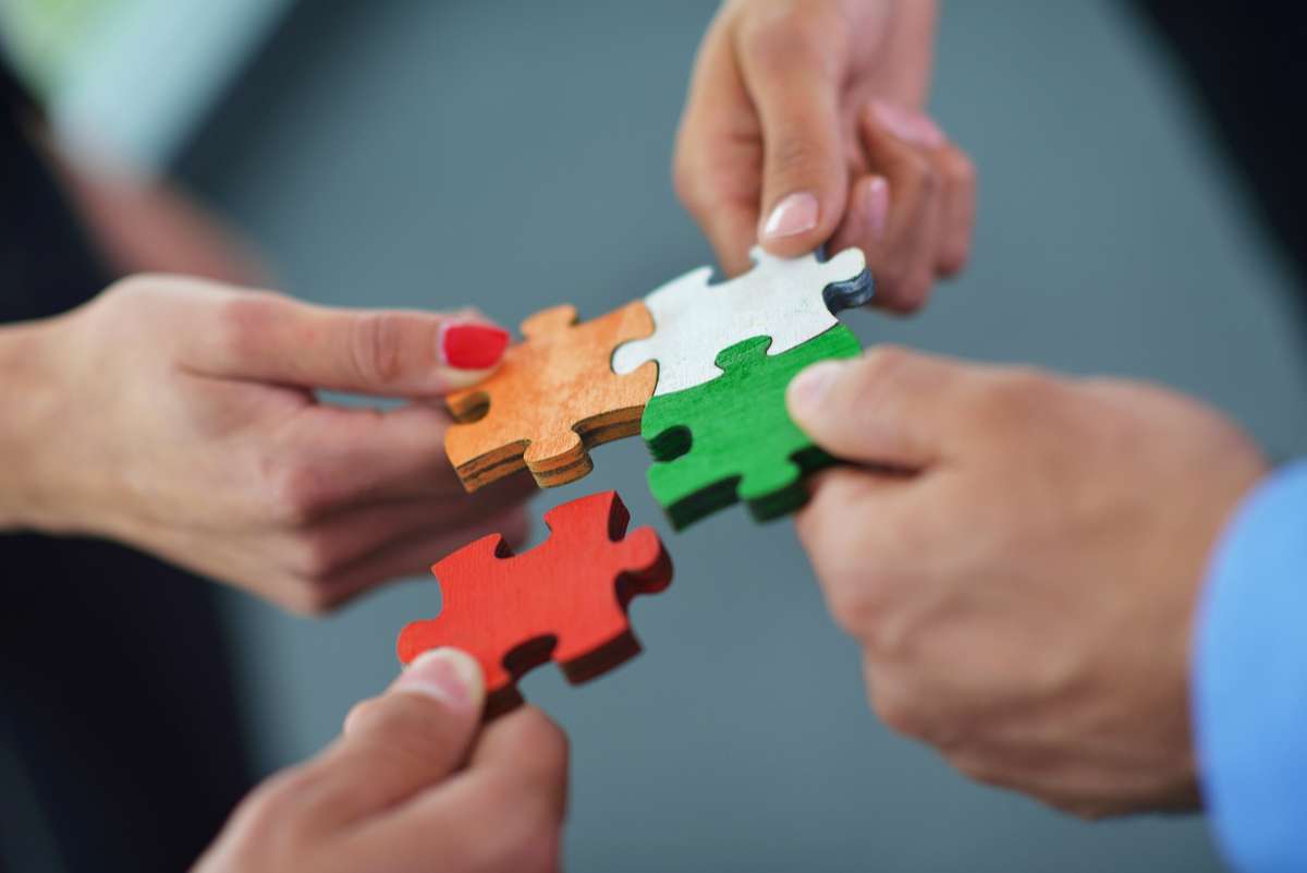 Group of business assembling jigsaw puzzle (R) (S)