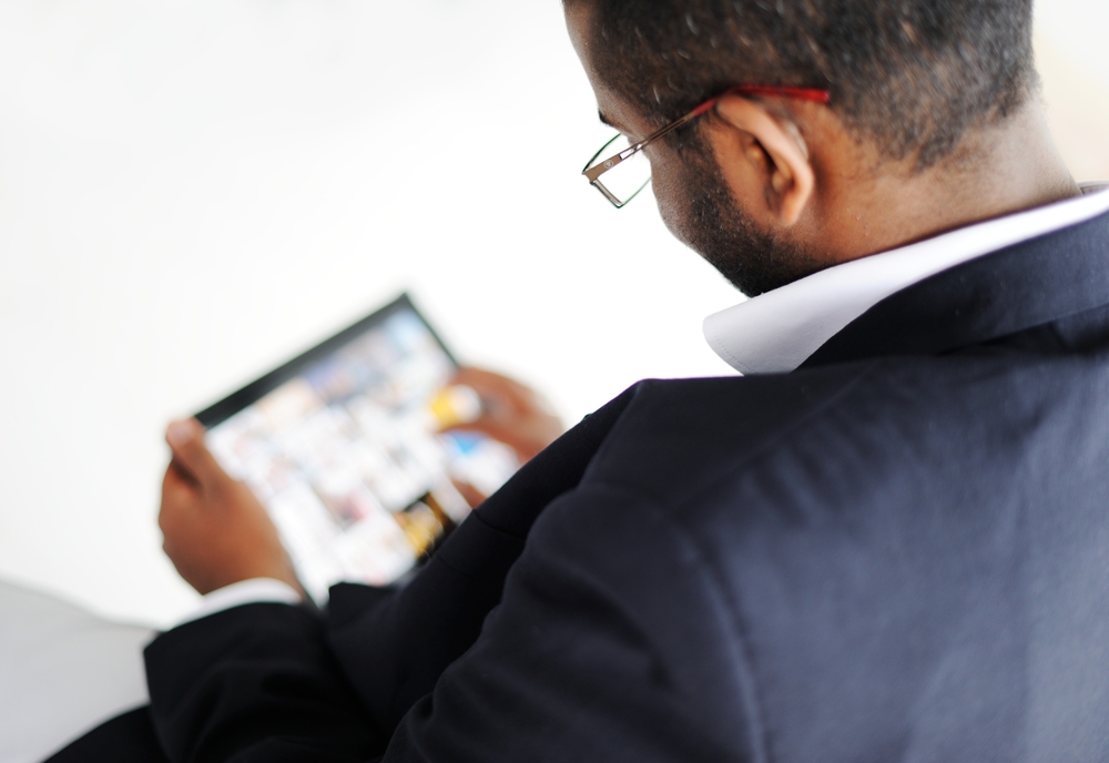 Handsome African American man with tablet computer