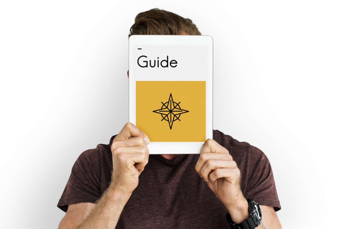 Man holding up digital guide, what is a pillar page concept. 