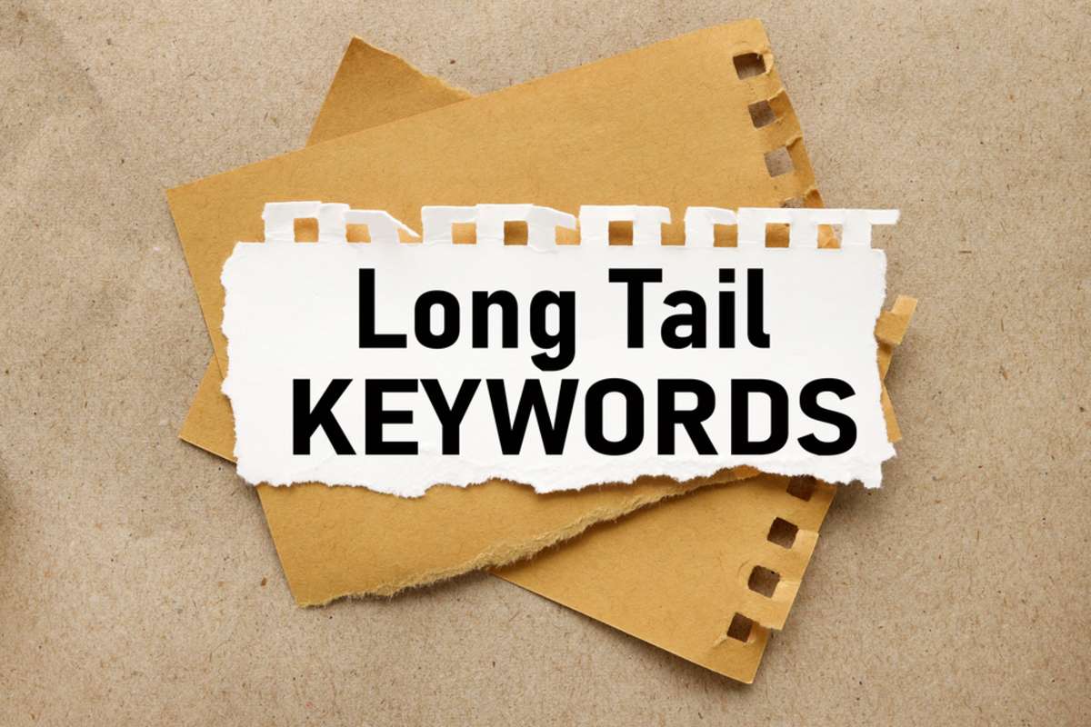 Long Tail Keywords, white torn paper on brown torn paper background