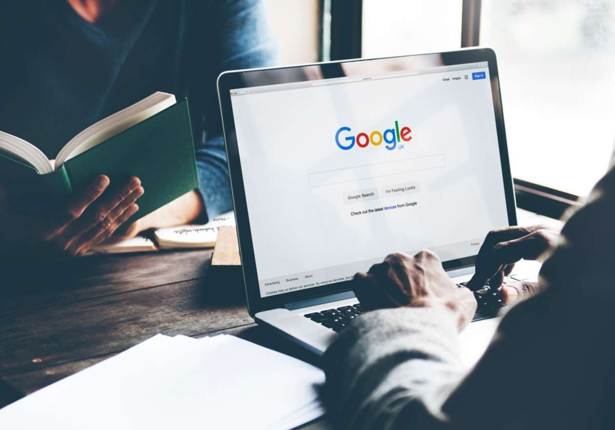 Man Using Laptop Browsing Google Website