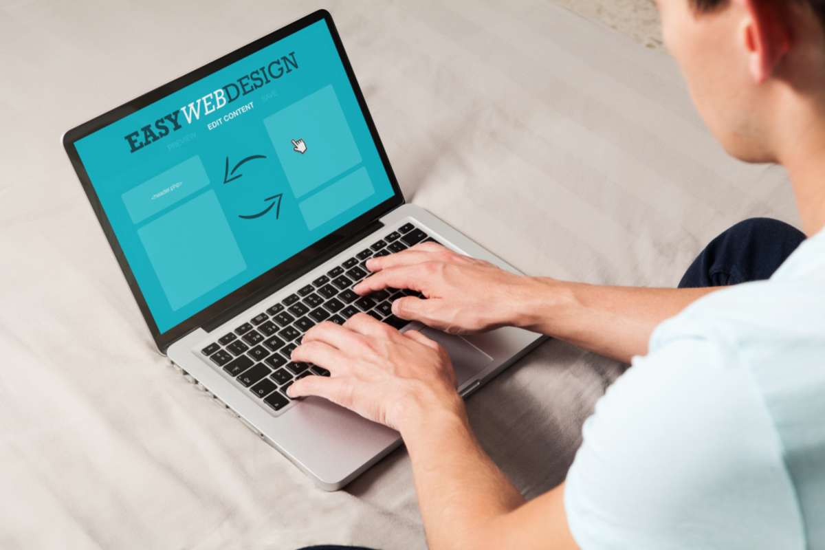 Man using a laptop computer to make web design at home
