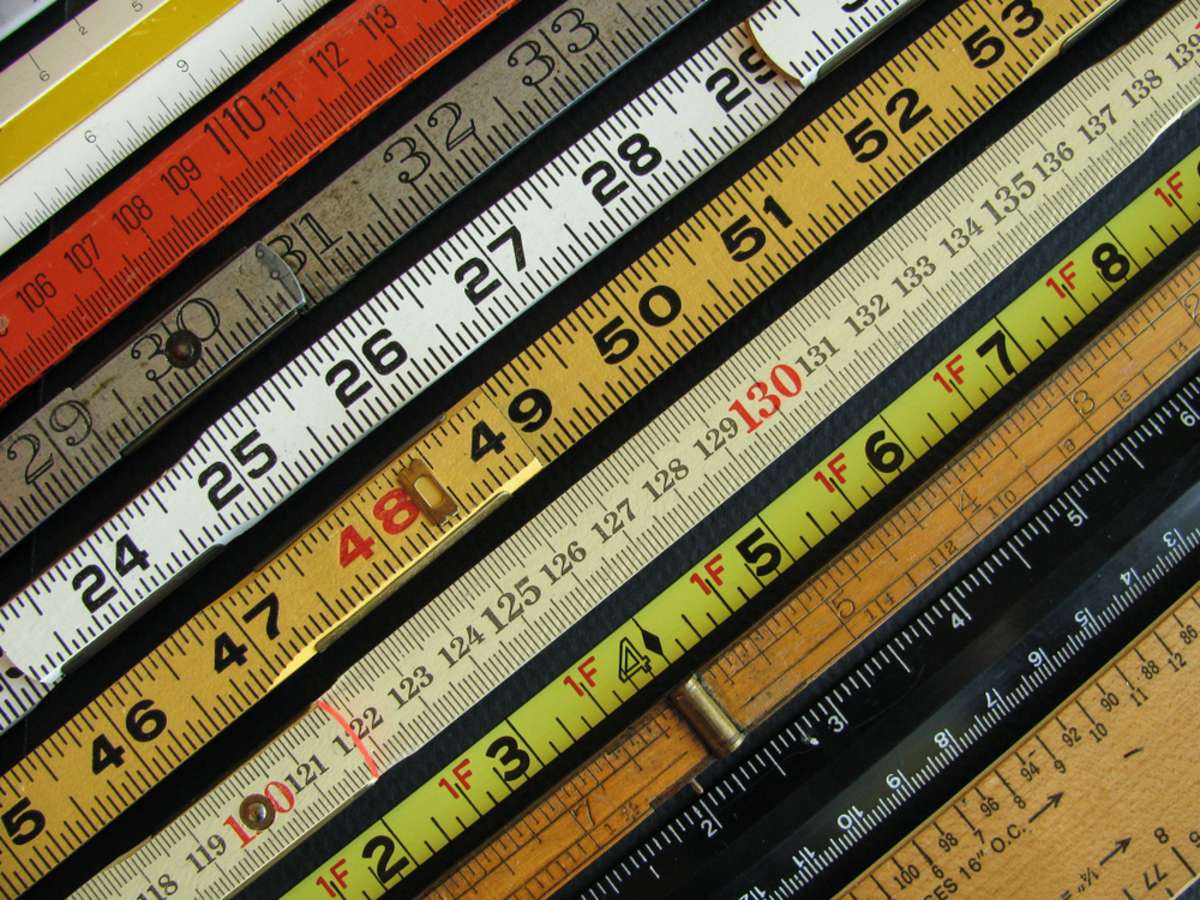 Old rulers both metric and inches, scales and measuring tools represent measurement
