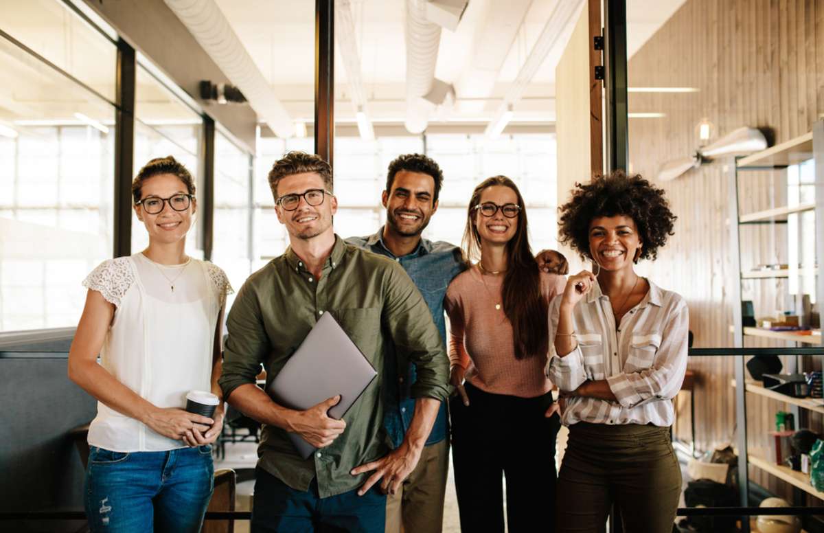 Portrait of successful creative business team looking at camera and smiling