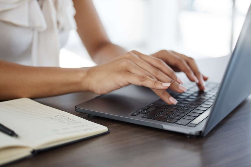 Research, laptop and hands of business woman researching messaging for real estate marketing.