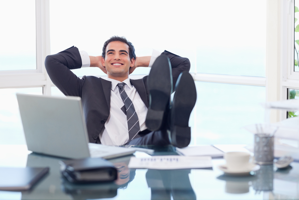 Satisfied businessman relaxing in his office