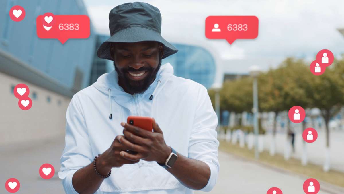Stylish young bearded african american man with hat walks uses phone smiles city male smart vlogger influencer animation with user interface