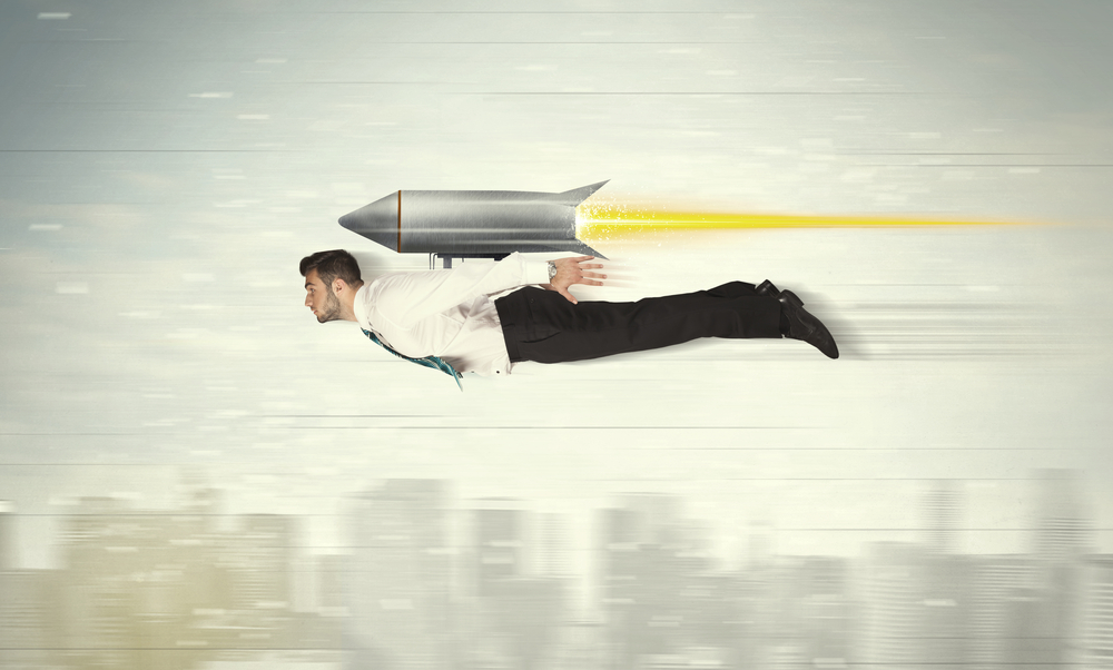 Superhero businessman flying with jet pack rocket above the city concept
