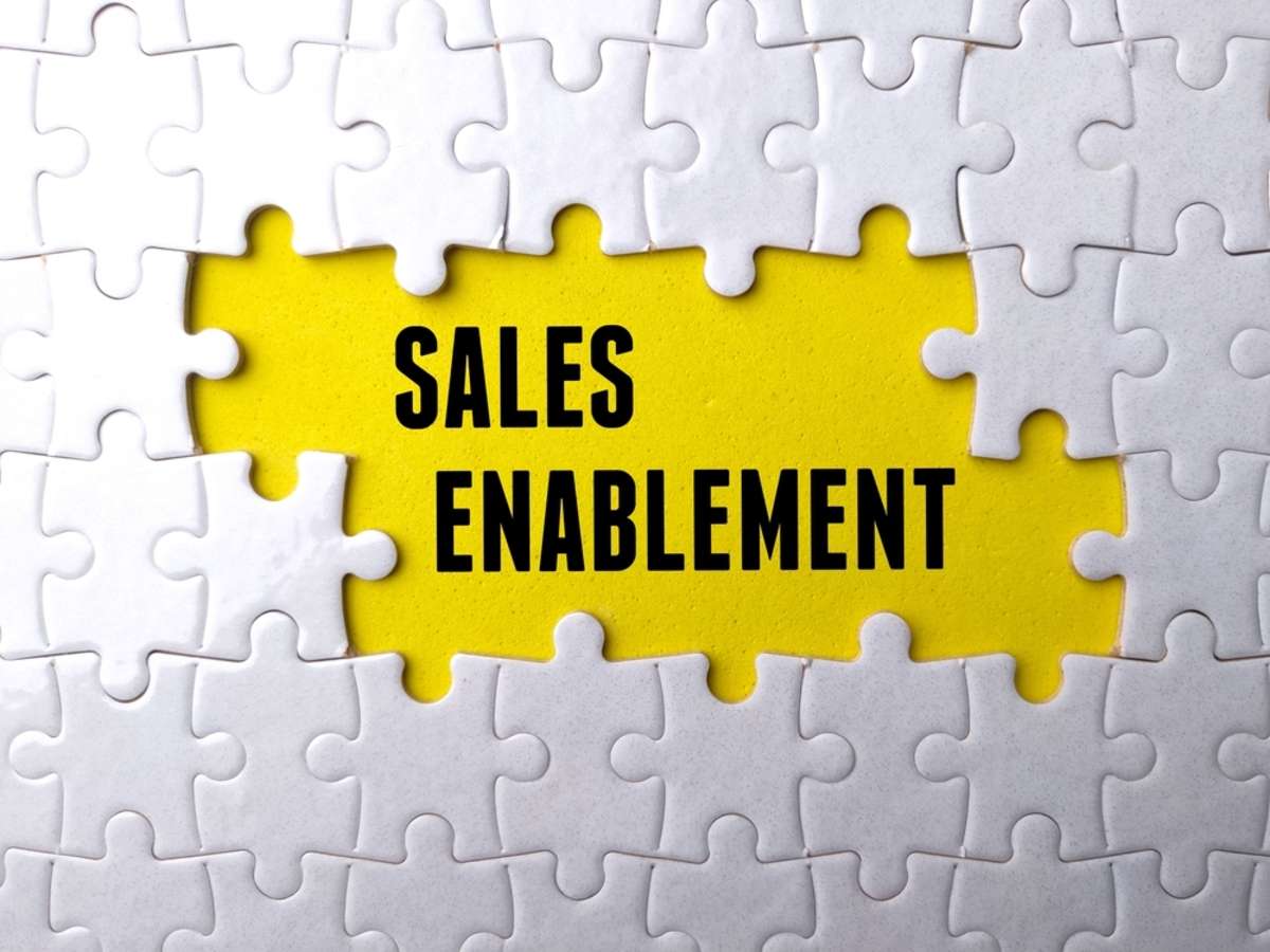 Text SALES ENABLEMENT written on yellow background with white puzzle.