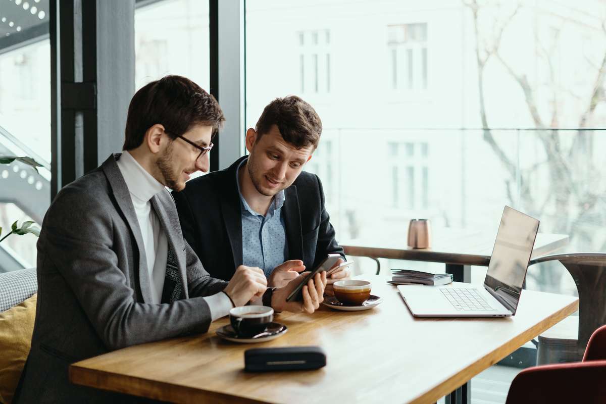 Two young businessman having a successful meeting at restaurant