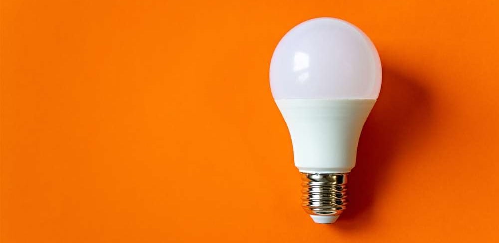 White energy saving light bulb isolated on an orange background-1