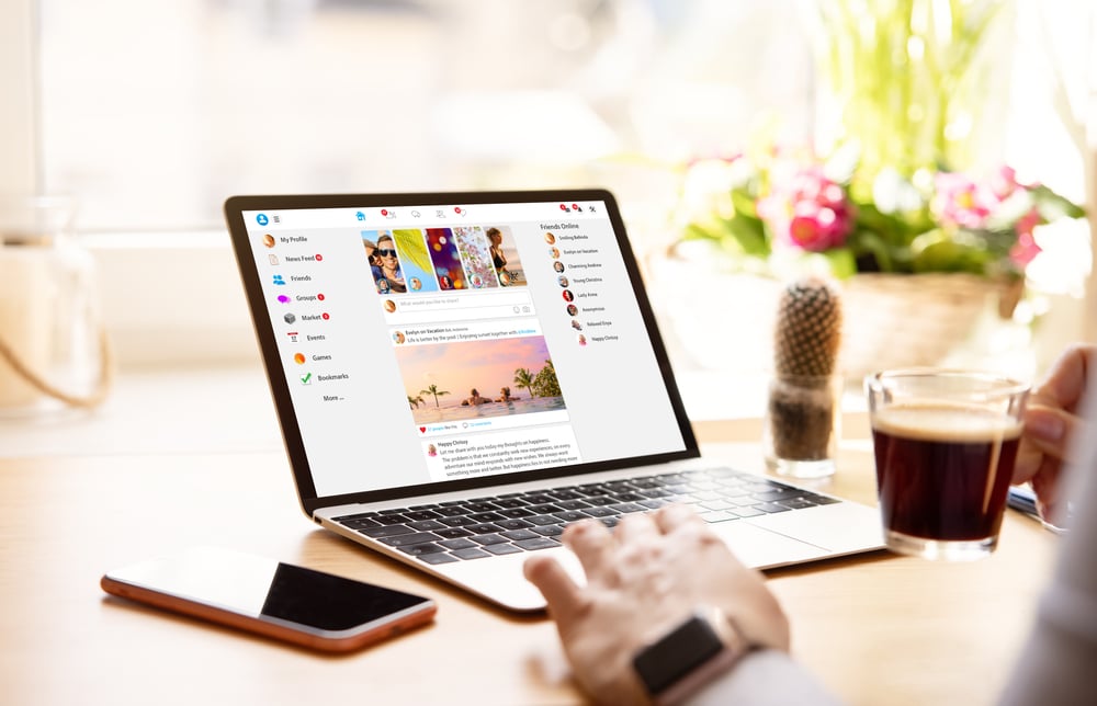 Woman using social media on laptop computer