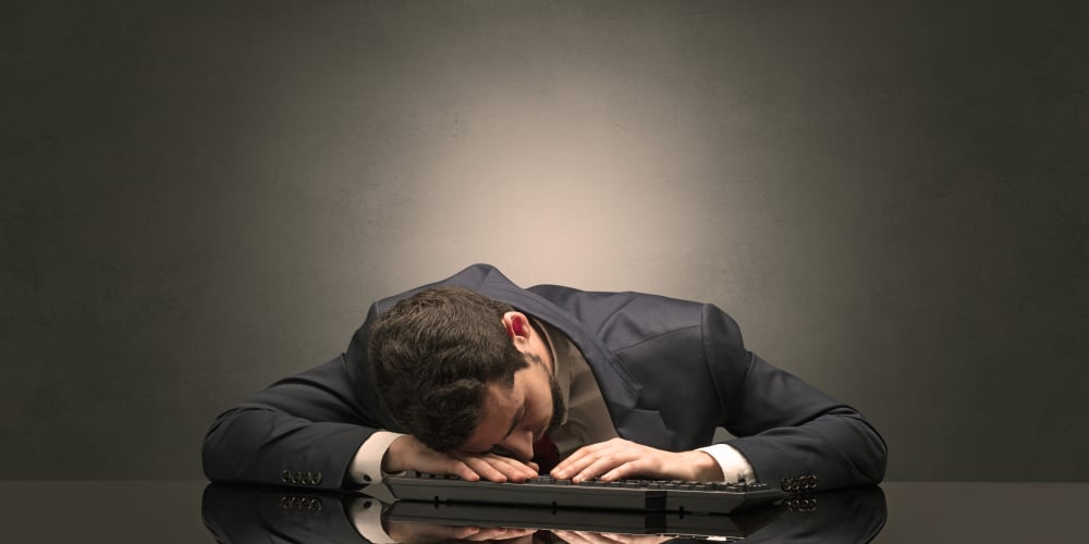 Young businessman fell asleep at his workplace with copy space