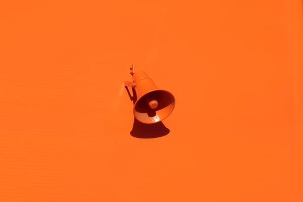 orange megaphone on orange background