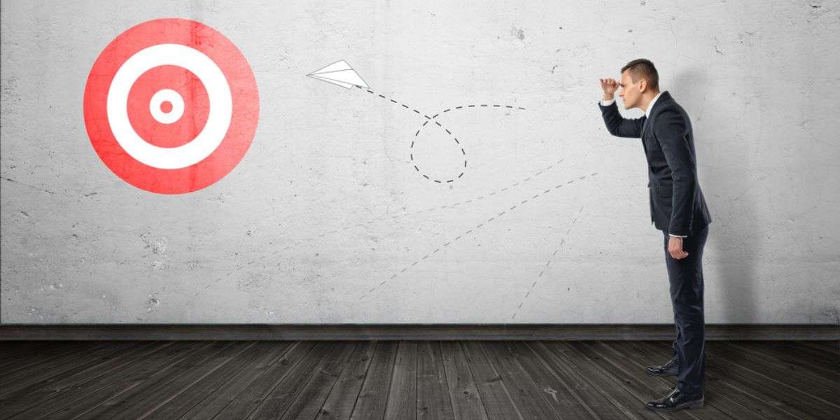 Businessman keeping track of the paper airplane flying right on target. Long-term plan