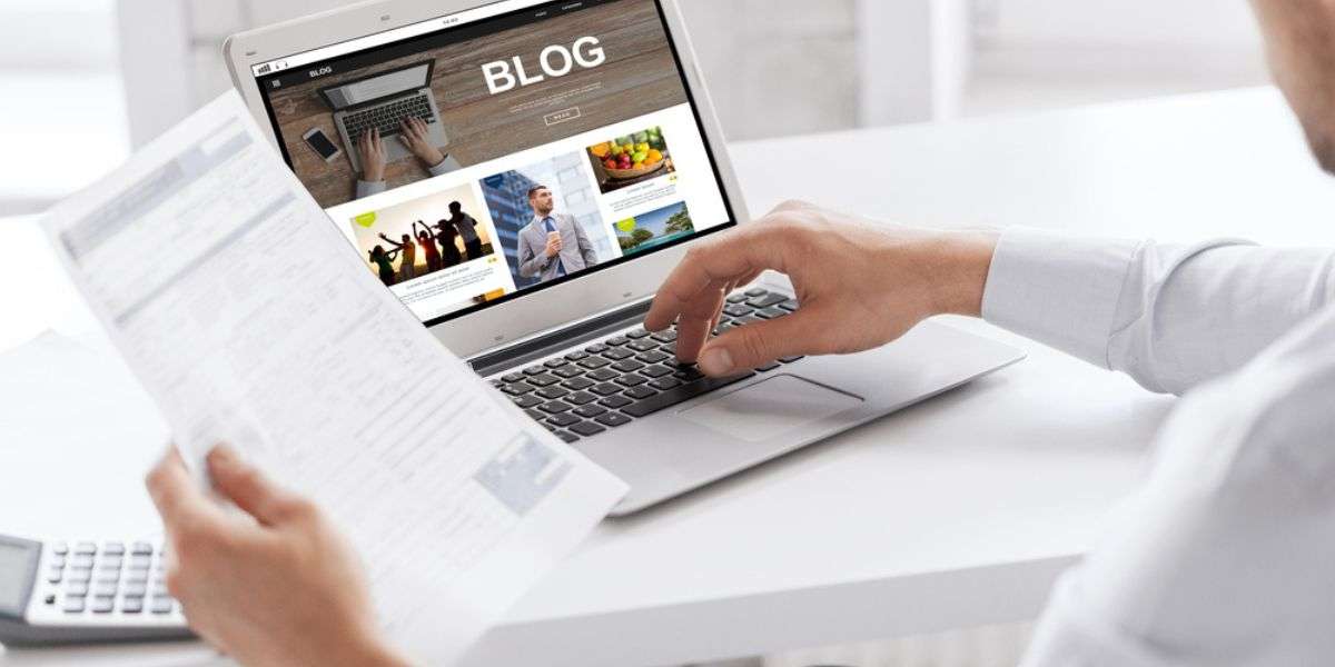 business, blogging, technology and people concept - businessman with internet blog page on laptop