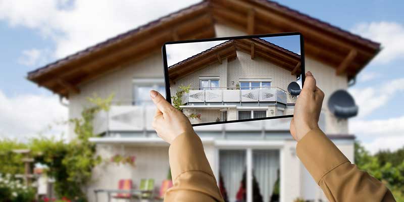 taking-video-of-house-roof-using-tablet-for-marketing