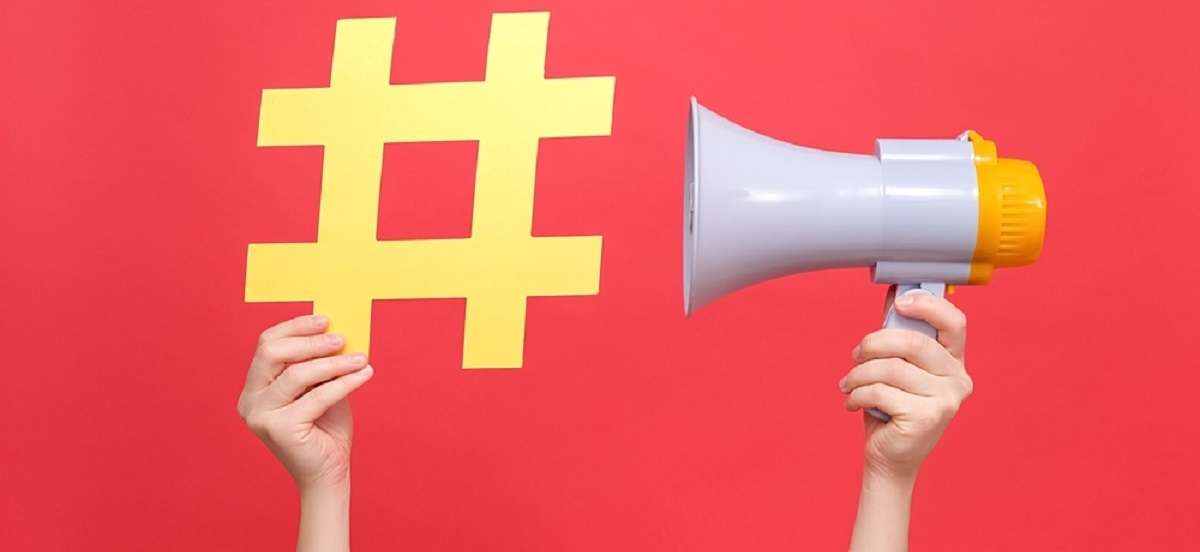 Close up female hands holding yellow hashtag sign and megaphone 8