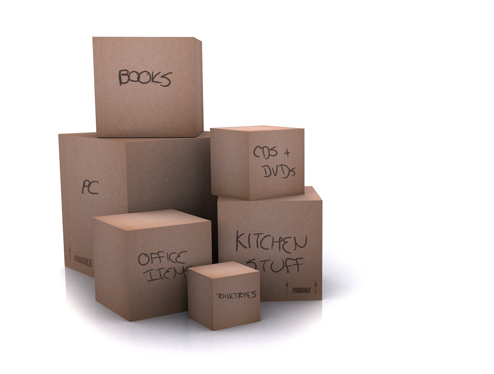 cardboard boxes - moving homes - over a white background - writing on boxes